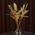 Искусственная веточка 63 см с ажурными блестящими листьями золотистая оптом