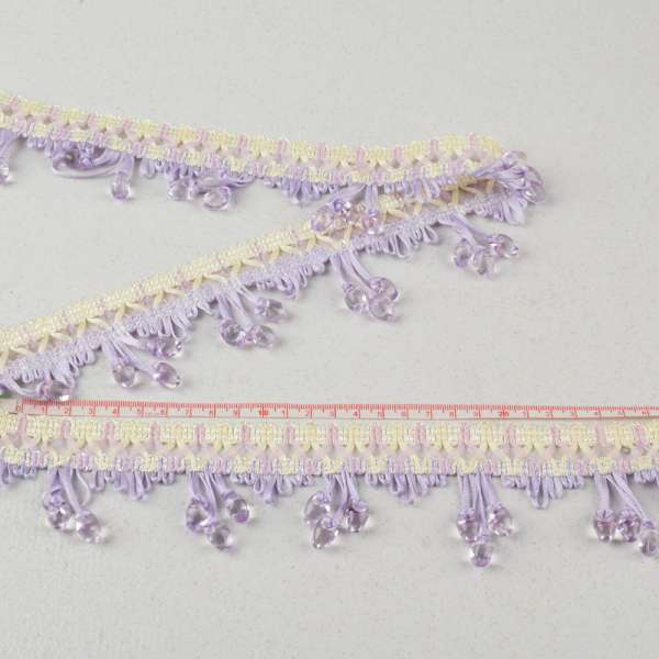 Бахрома з намистинами прозорими на плетеній тасьмі 60мм, фіолетова світла оптом